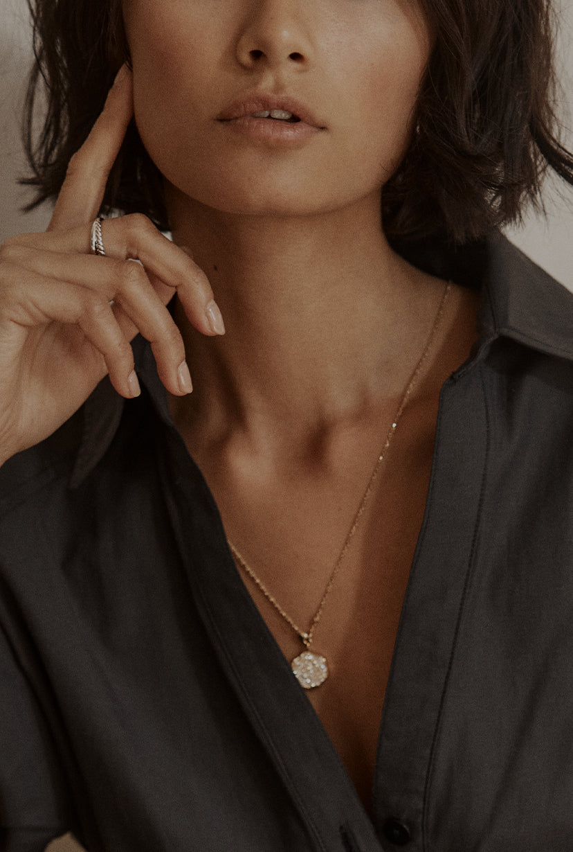 model wearing brochu walker gold and diamond flower shaped pendant