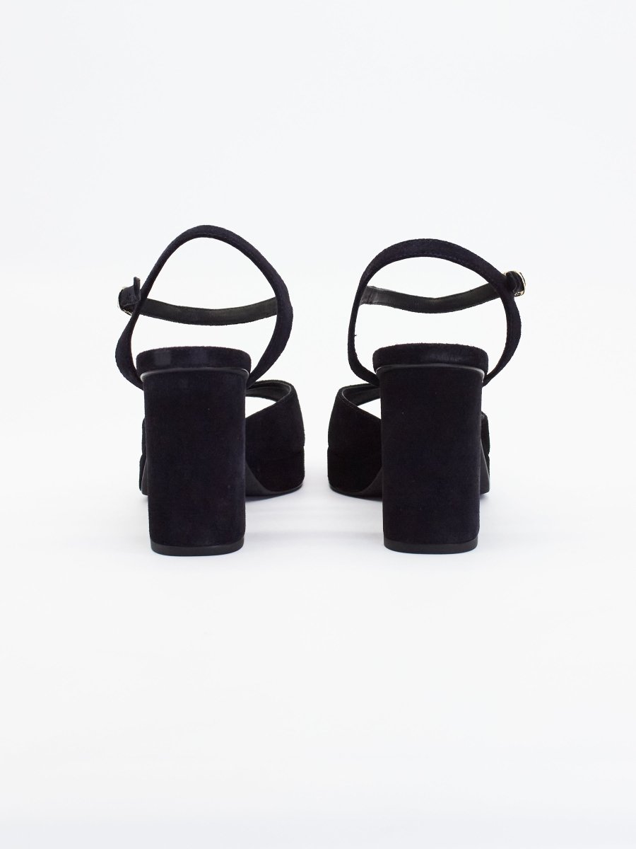Black heels for women with thick block heels, ankle straps, and suede finish shown from the back view.