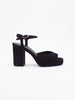Black heels for women featuring a block heel, platform sole, and ankle strap with a gold buckle.