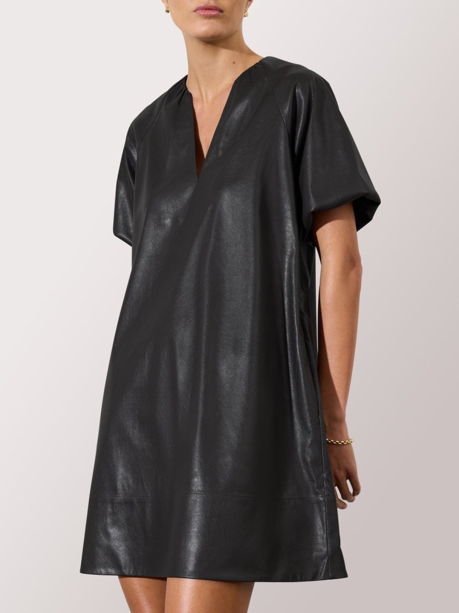 Women's black leather dress with short sleeves, V-neckline, and a loose, minimalist silhouette.