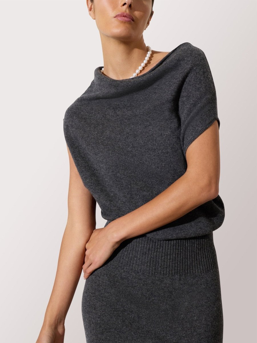 Women's gray knit dress with a wide neckline and cap sleeves, styled with a classic pearl necklace.
