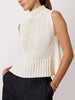 White knitted tank top for women featuring a high ribbed neckline and relaxed fit paired with dark trousers.