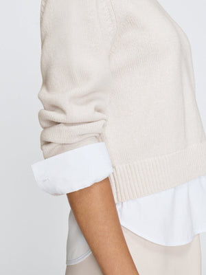 Crewneck sweater for women in cloudy brown, layered over a white shirt.