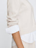 Crewneck sweater for women in cloudy brown, layered over a white shirt.