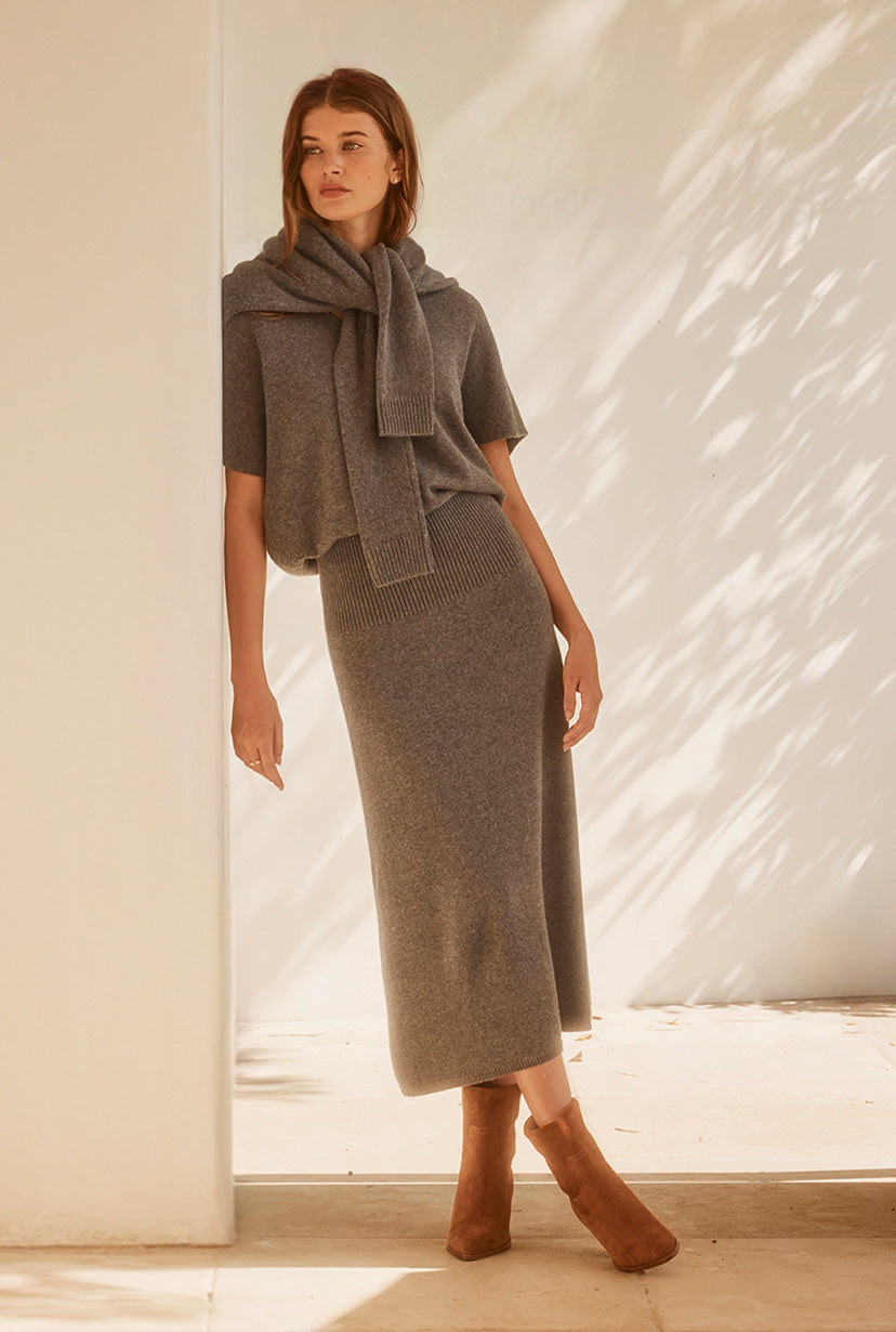 model wearing broch knitwear shirt and skirt