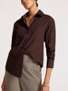 Brown button up shirt for women with single breast pocket, relaxed collar and long sleeves, styled tucked into neutral trousers