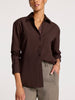 Women’s brown button-up shirt in soft cotton with chest pocket and casual collar, styled tucked into taupe trousers