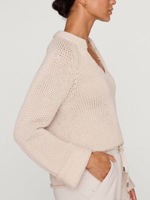 Aria stand collar deep v neckline beige sweater side view